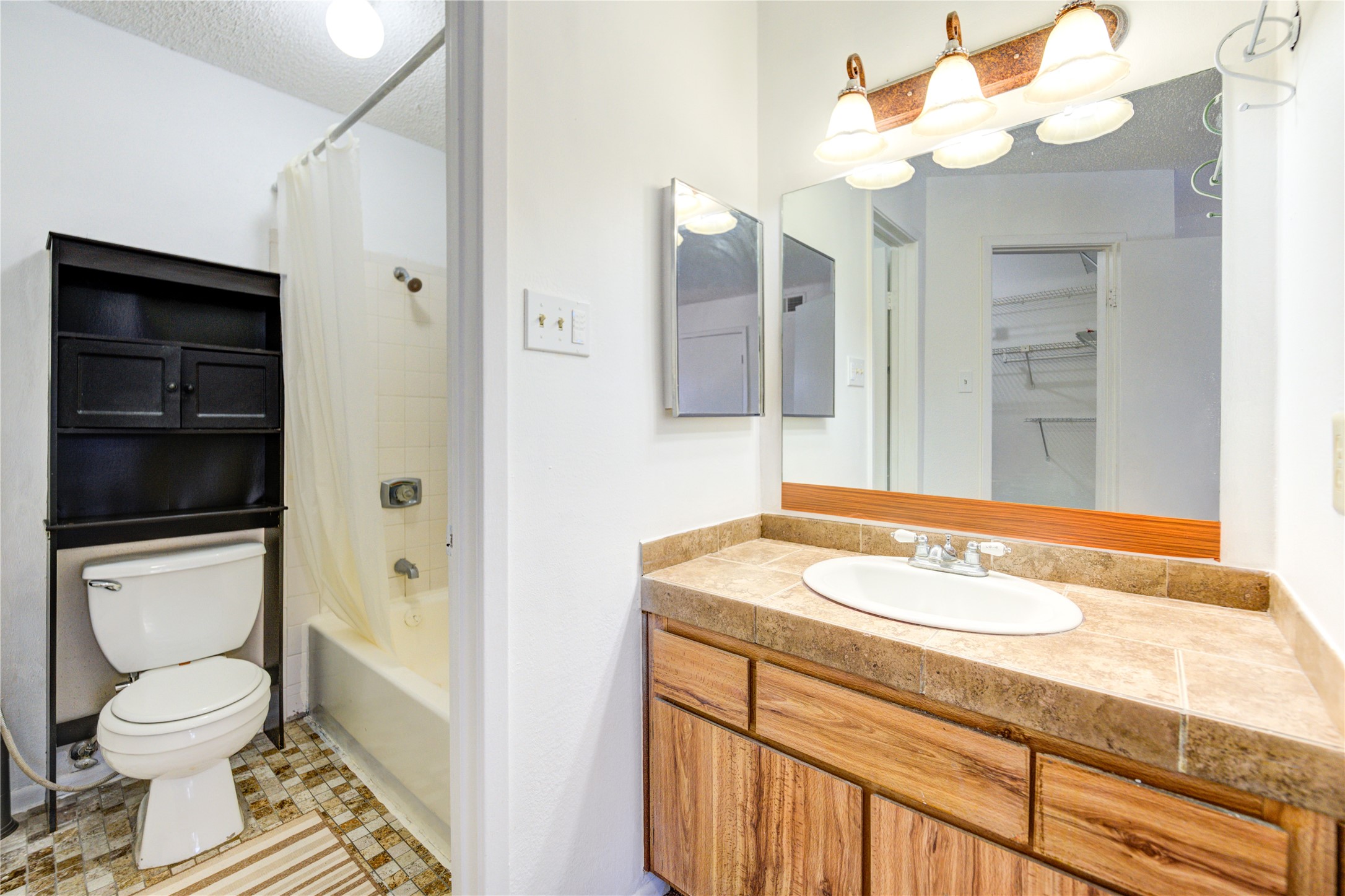 2800 Jeanetta Street, Unit 2504 Houston, TX 77063 - Photo 39 of 49 a bathroom with a sink a toilet and a mirror