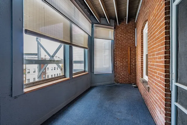 a view of entryway with wooden floor and door