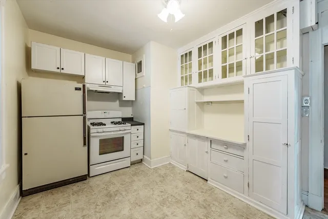 a kitchen with cabinets and stainless steel appliances