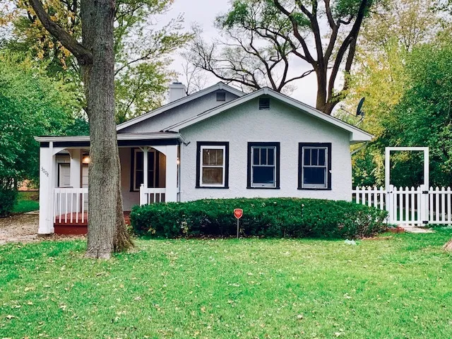 a front view of a house with a garden and plants