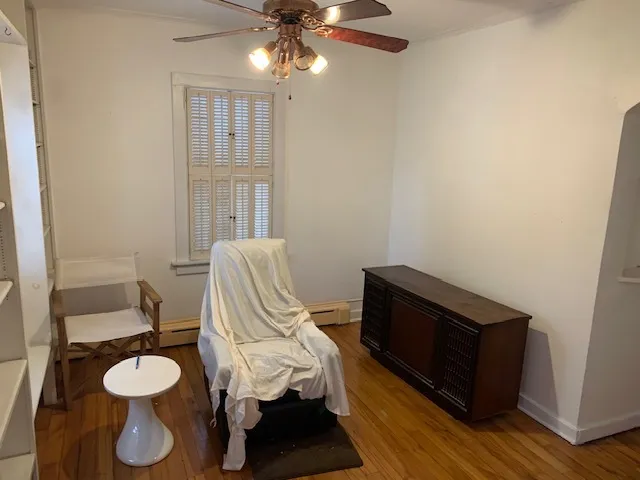 a view of a room with furniture and wooden floor