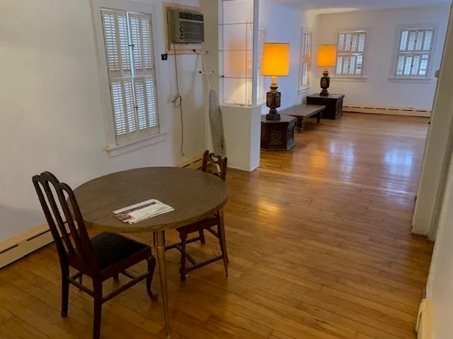 a view of a dining room with furniture and a chandelier