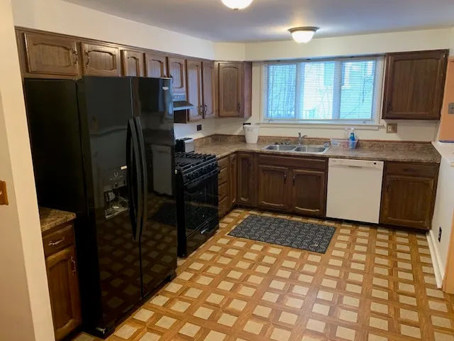 a kitchen with a refrigerator stove and sink