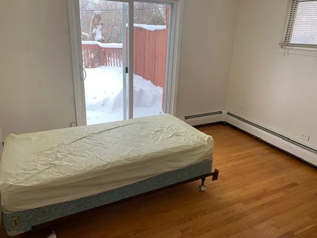a bedroom with a bed and window