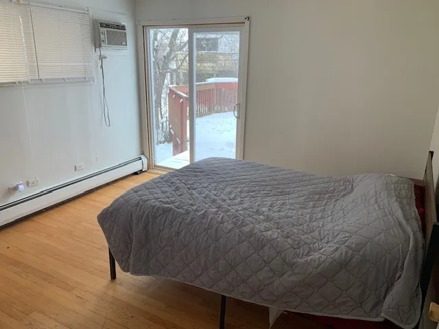 a bed sitting in a bedroom next to a window