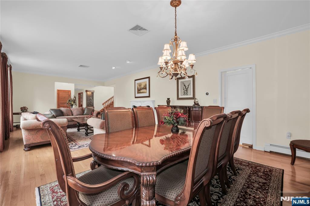 738 Ridge Road Butler, NJ 07405 - Photo 16 of 50 a view of a dining room with furniture a chandelier and wooden floor
