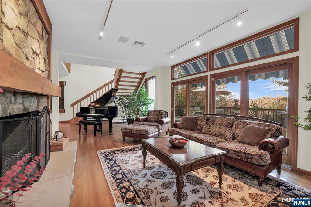 738 Ridge Road Butler, NJ 07405 - Photo 18 of 50 a living room with furniture a rug and a floor to ceiling window
