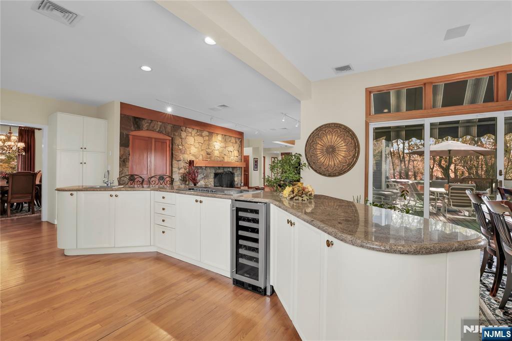 738 Ridge Road Butler, NJ 07405 - Photo 23 of 50 a kitchen with a sink cabinets and a wooden floor