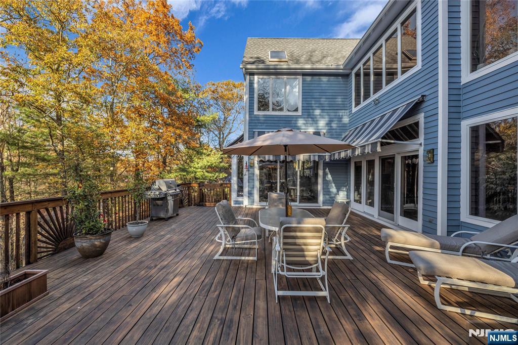 738 Ridge Road Butler, NJ 07405 - Photo 27 of 50 a view of a patio with table and chairs and wooden floor