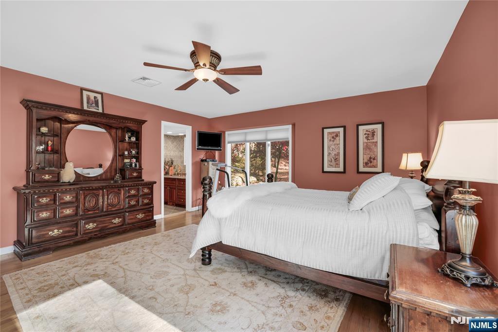 738 Ridge Road Butler, NJ 07405 - Photo 32 of 50 a bed room with a bed a dresser and chair