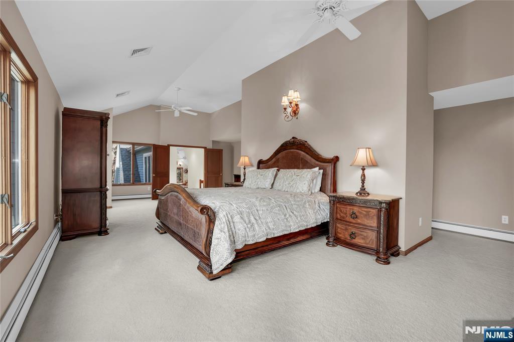 738 Ridge Road Butler, NJ 07405 - Photo 35 of 50 a bedroom with a bed lamp closet and large window