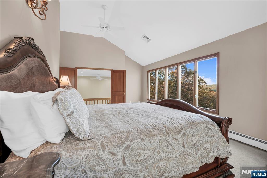 738 Ridge Road Butler, NJ 07405 - Photo 36 of 50 a bed sitting in a bedroom next to a window