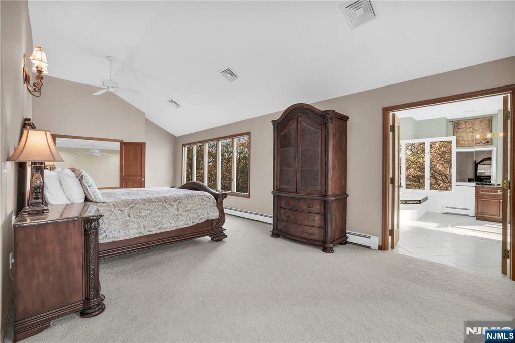 738 Ridge Road Butler, NJ 07405 - Photo 37 of 50 a bedroom with a bed and dresser with mirror