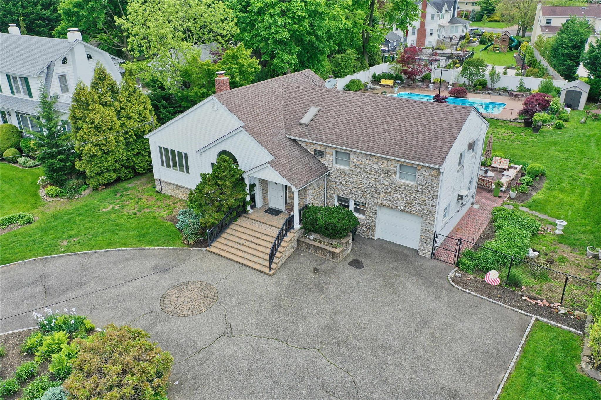 an aerial view of a house with a yard and a garden