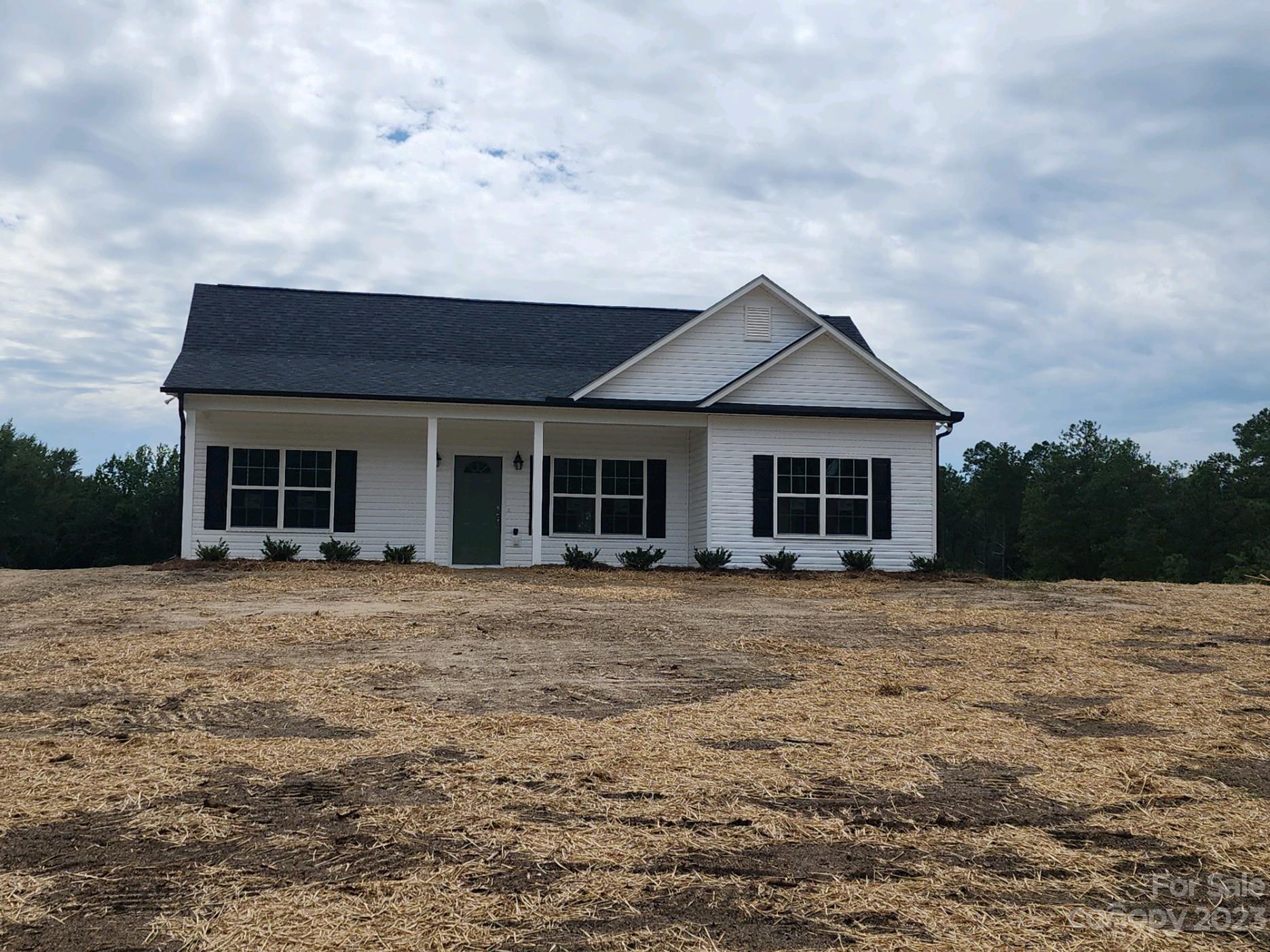 767 Crow Burk Road Pageland, SC 29728 - Photo 1 of 13 a front view of a house with garden