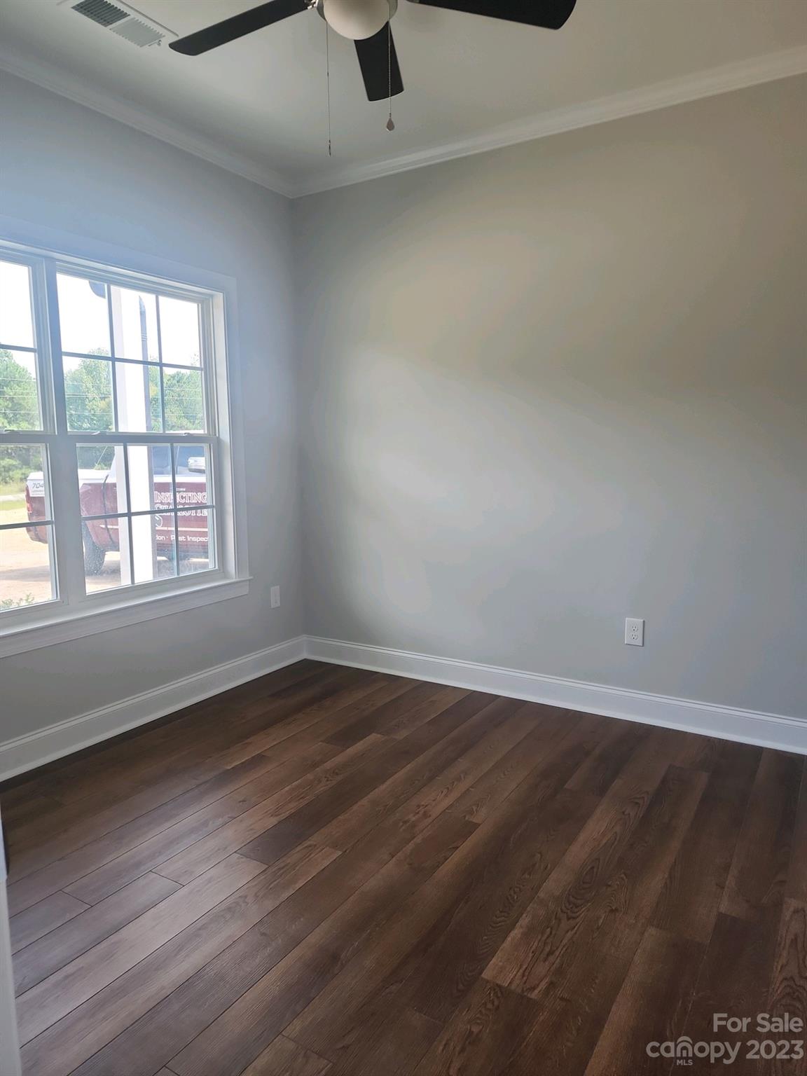 767 Crow Burk Road Pageland, SC 29728 - Photo 11 of 13 an empty room with wooden floor and windows