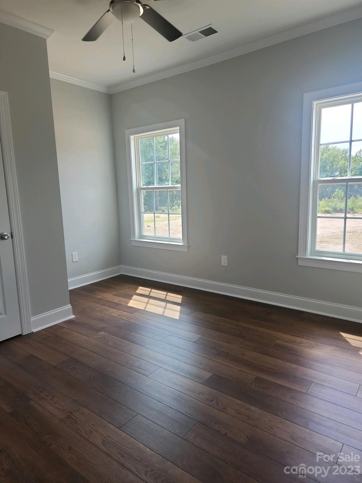 767 Crow Burk Road Pageland, SC 29728 - Photo 13 of 13 an empty room with wooden floor and windows