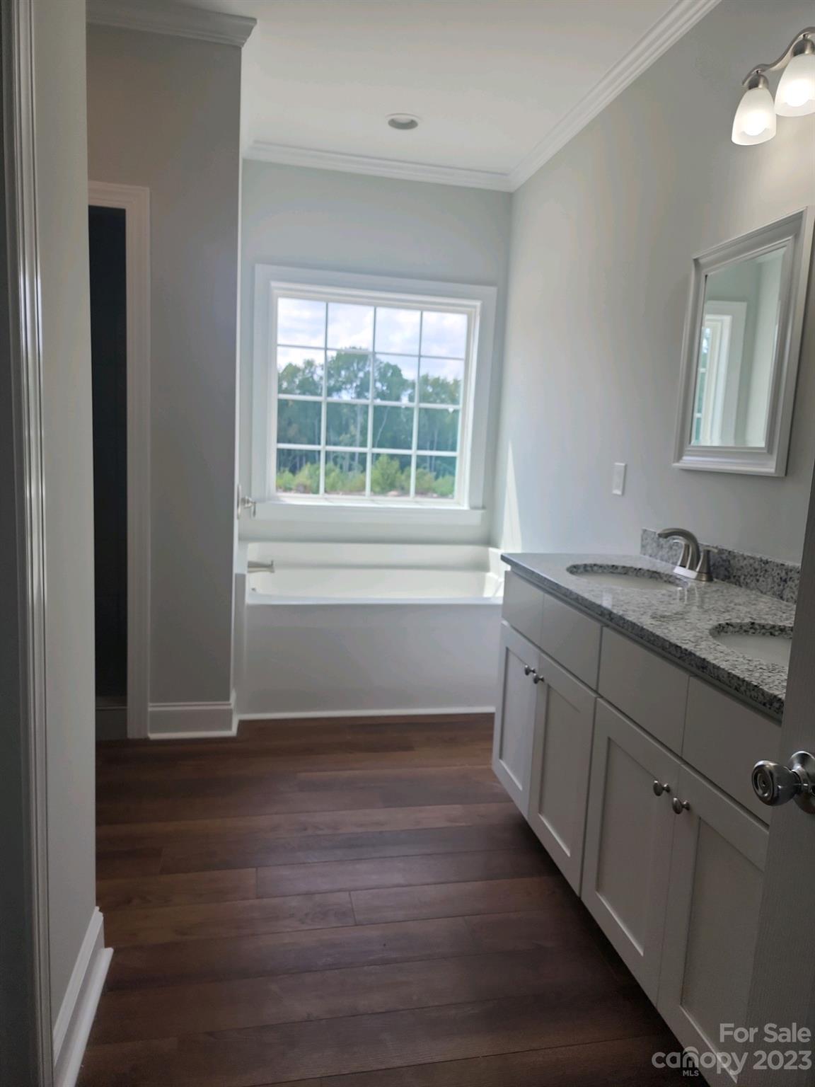 767 Crow Burk Road Pageland, SC 29728 - Photo 9 of 13 a view of an empty room with wooden floor and a window