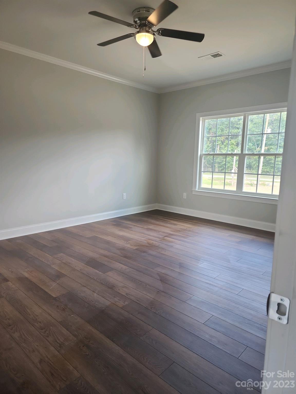 767 Crow Burk Road Pageland, SC 29728 - Photo 10 of 13 an empty room with wooden floor fan and windows