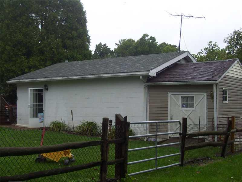 155 Cummings Road Acme, PA 15610 - Photo 2 of 4 Parking Lot/Garage. SIDE VIEW OF 2 CAR DETACHED GARAGE WITH ADDITION AND LARGE DOOR WITH RAMP TO STORE MOWER OR TOYS LARGE GATE IN REAR OF YARD TO BRING TOYS OR MOWER INTO YARD OR GARAGE
