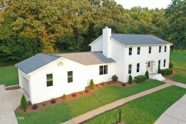 a view of house with yard