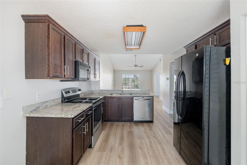 7900 Hardwick Drive, Unit 827 New Port Richey, FL 34653 - Photo 8 of 27 a kitchen with a sink stove and refrigerator
