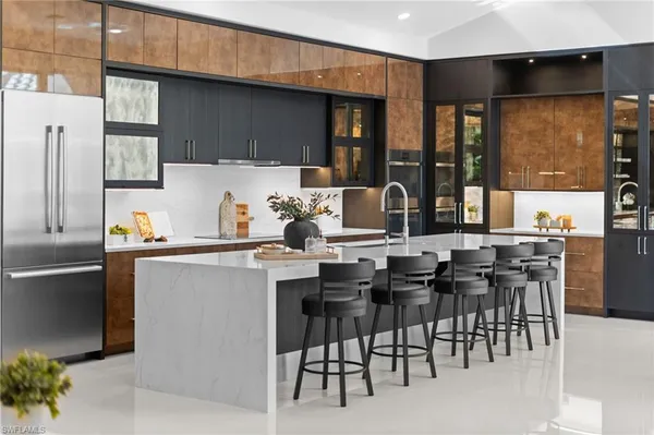 a kitchen with a table chairs and a refrigerator