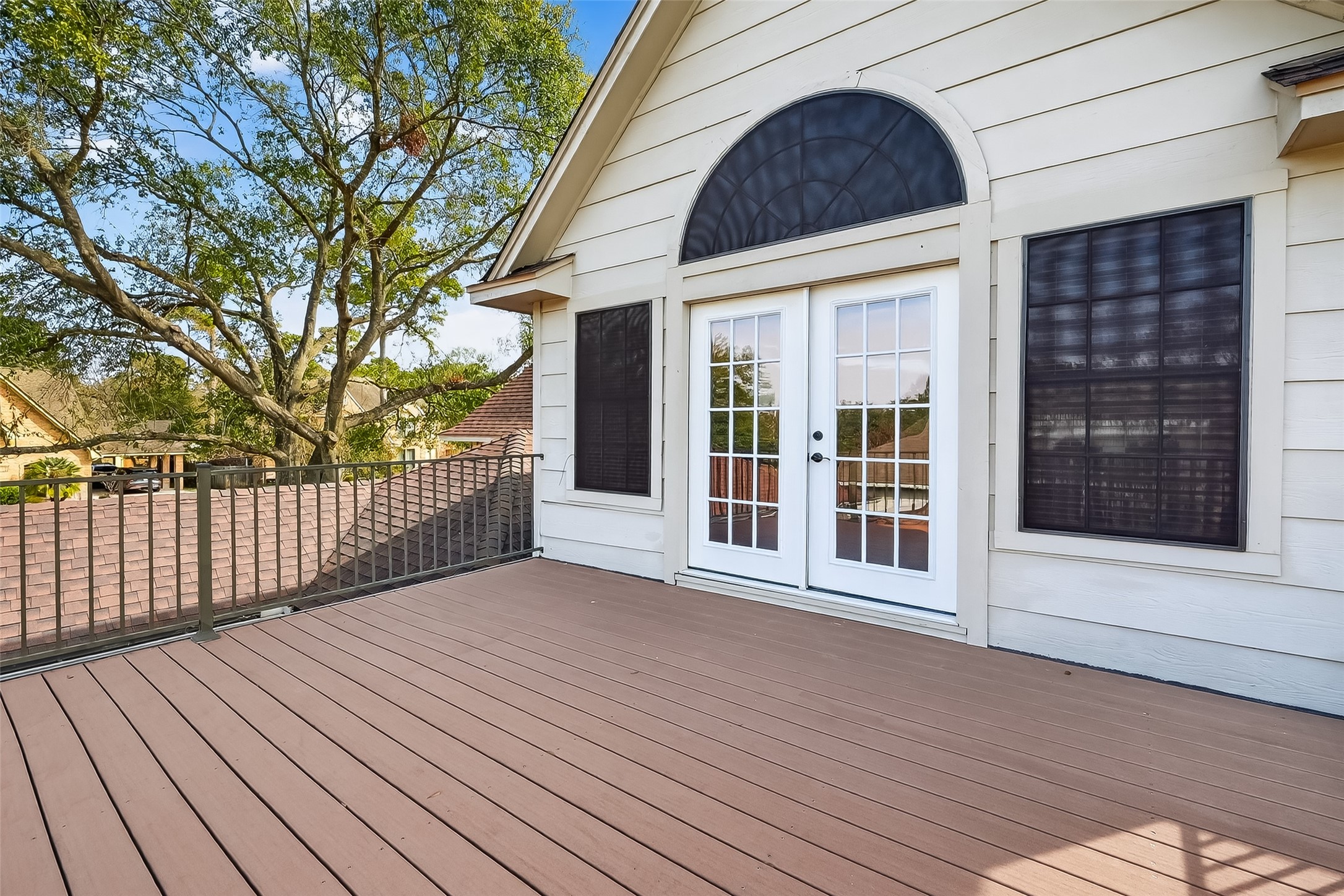5802 Ashmere Lane Spring, TX 77379 - Photo 34 of 41 Spacious rooftop deck with elegant French doors and scenic views, ideal for outdoor relaxation and entertaining.