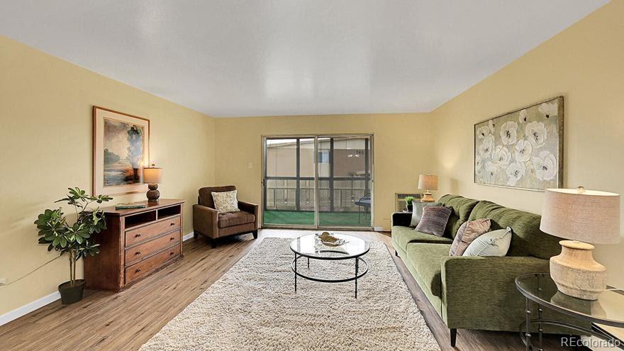 725 South Clinton Street, Unit 1B Denver, CO 80247 - Photo 13 of 22 a living room with furniture and a large window