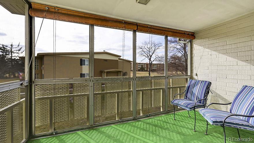 725 South Clinton Street, Unit 1B Denver, CO 80247 - Photo 14 of 22 a balcony view with a large window and sitting area