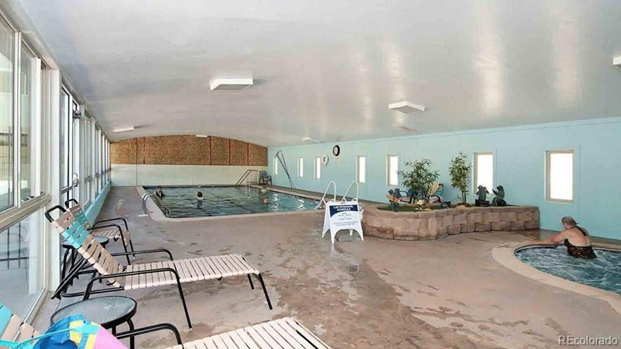 725 South Clinton Street, Unit 1B Denver, CO 80247 - Photo 22 of 22 a living room with furniture and a table