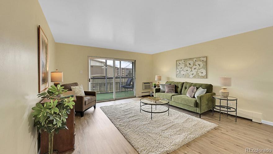 725 South Clinton Street, Unit 1B Denver, CO 80247 - Photo 4 of 22 a living room with furniture and a potted plant