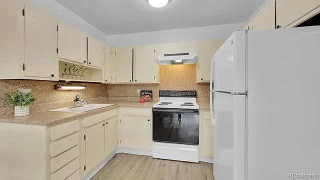 a kitchen with a sink a stove and cabinets
