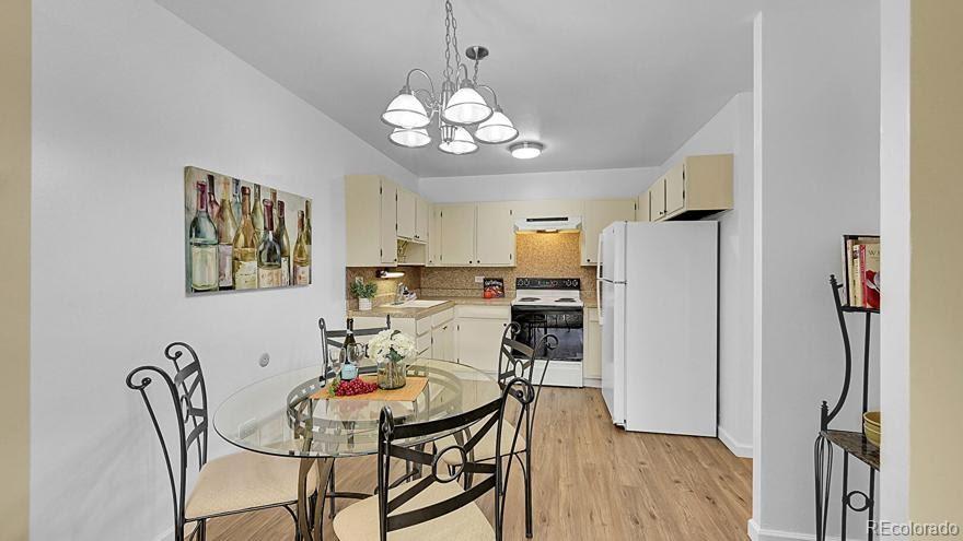 725 South Clinton Street, Unit 1B Denver, CO 80247 - Photo 7 of 22 a view of a dining room with furniture and wooden floor
