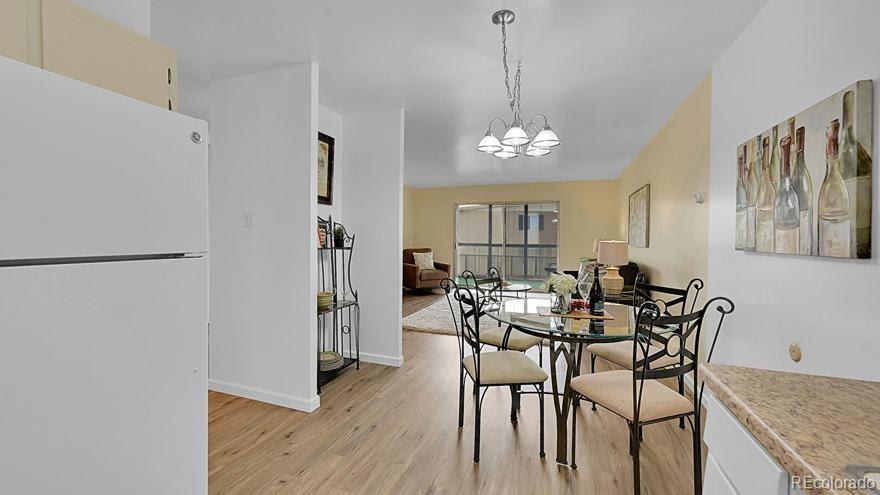 725 South Clinton Street, Unit 1B Denver, CO 80247 - Photo 8 of 22 a view of a dining room with furniture and wooden floor
