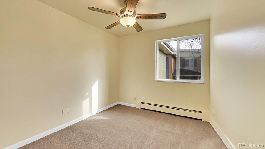 725 South Clinton Street, Unit 1B Denver, CO 80247 - Photo 10 of 22 an empty room with a fan & a window