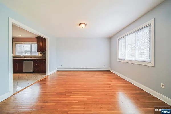 a view of a kitchen with wooden floor and a kitchen