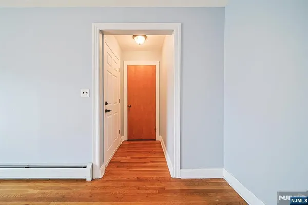 a view of a hallway with wooden floor