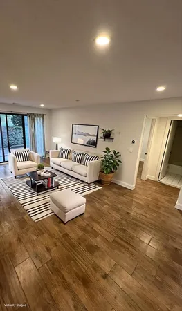 a spacious bathroom with a mirror and a rug