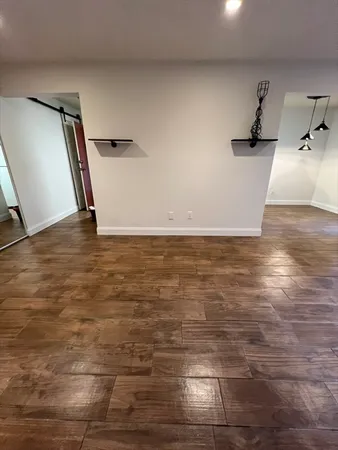 a view of a room with wooden floor