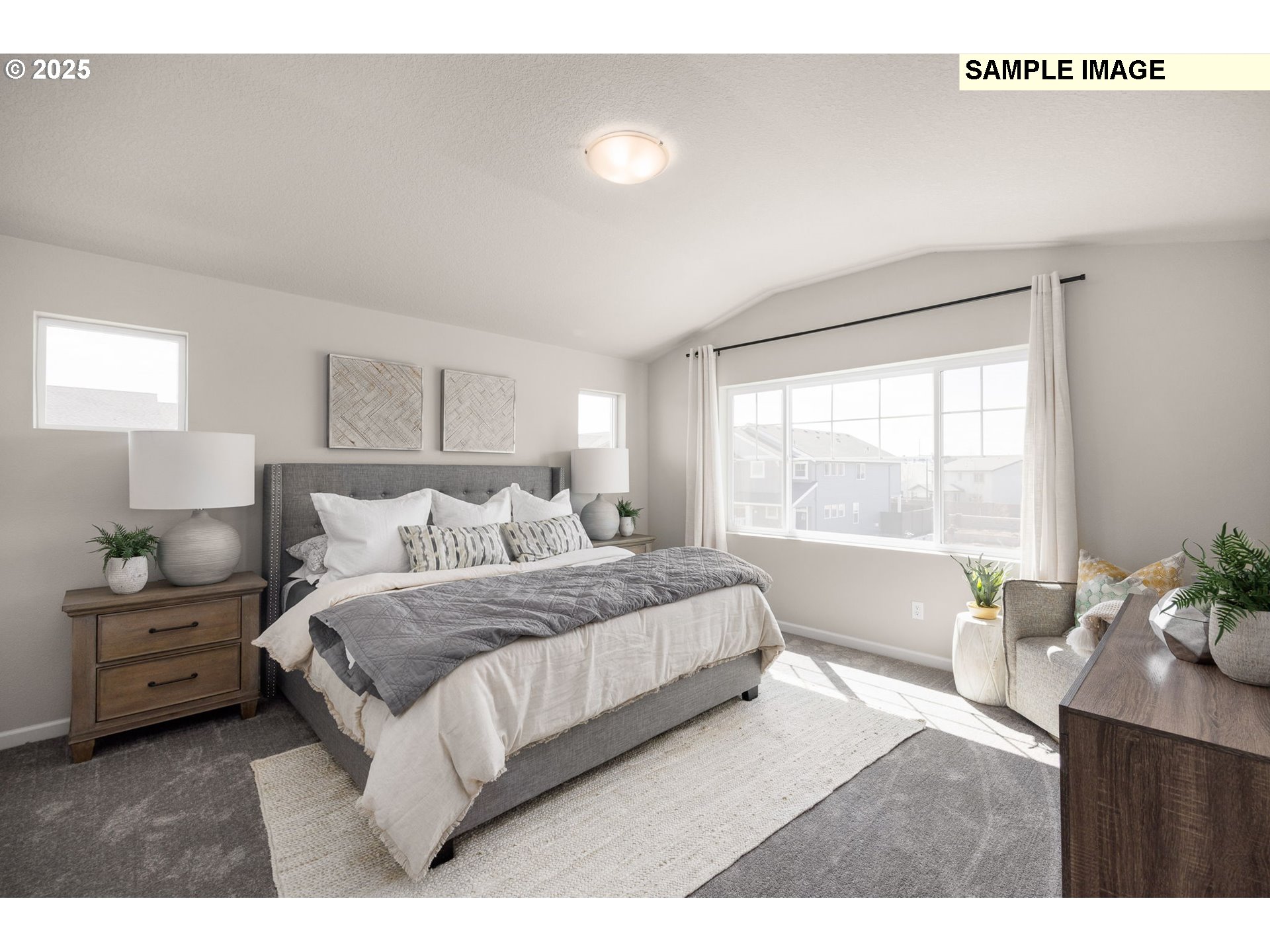 8916 Southwest Choke Cherry Tualatin, OR 97062 - Photo 18 of 29 a bedroom with a large bed and a large window