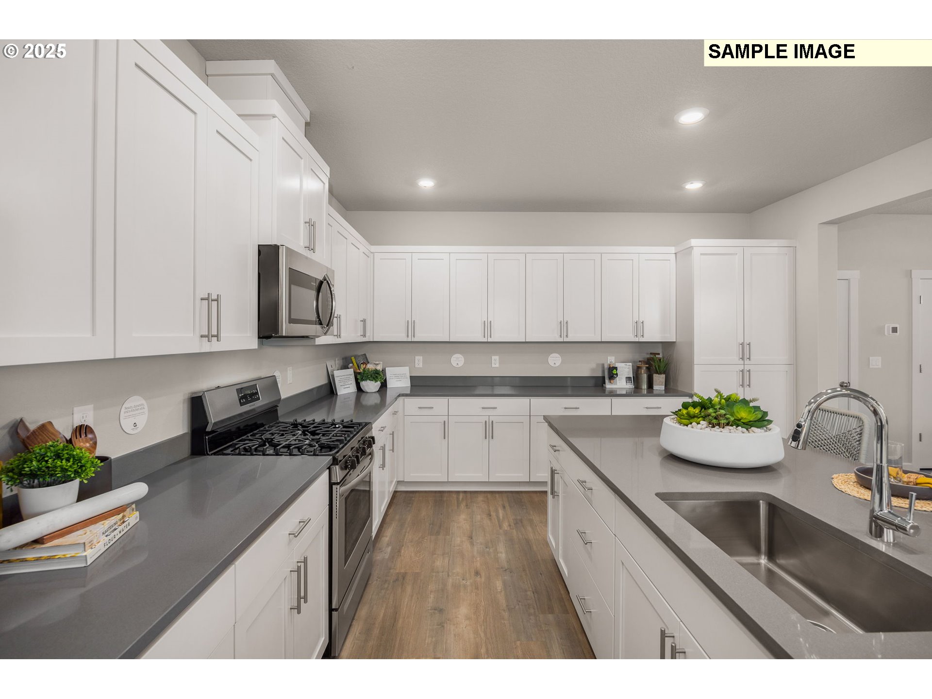 8916 Southwest Choke Cherry Tualatin, OR 97062 - Photo 8 of 29 a kitchen with a sink stove top oven and microwave