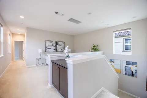 a living room with furniture and a wall painting