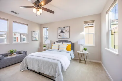 a bed sitting in a bedroom next to a window