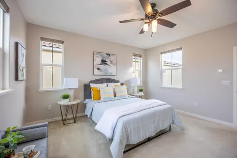 a bedroom with a large bed and a chandelier