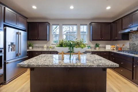 a kitchen with stainless steel appliances granite countertop a sink and dishwasher