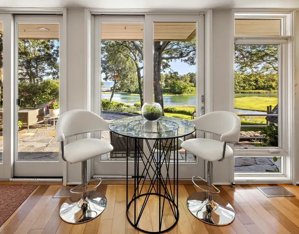 a dining room with furniture wooden floor and a chandelier