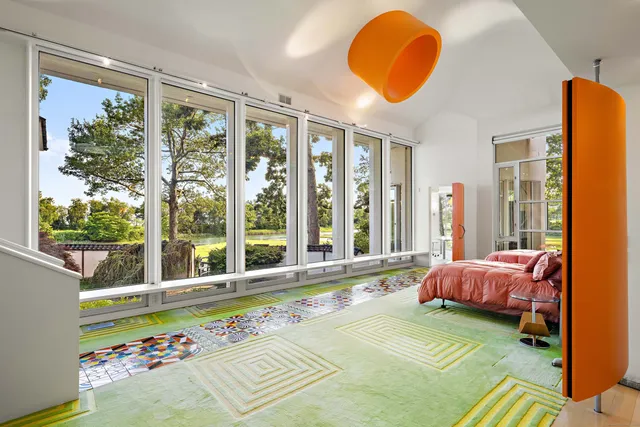 a spacious bedroom with a bed and a window