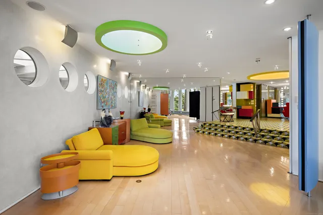 a living room with lots of furniture and a large mirror