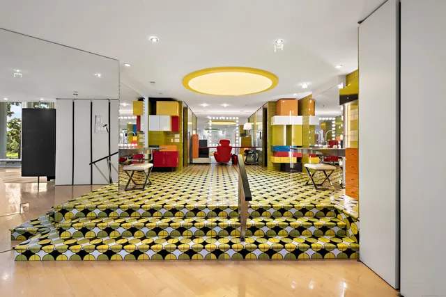 a living room with a rug table and chairs